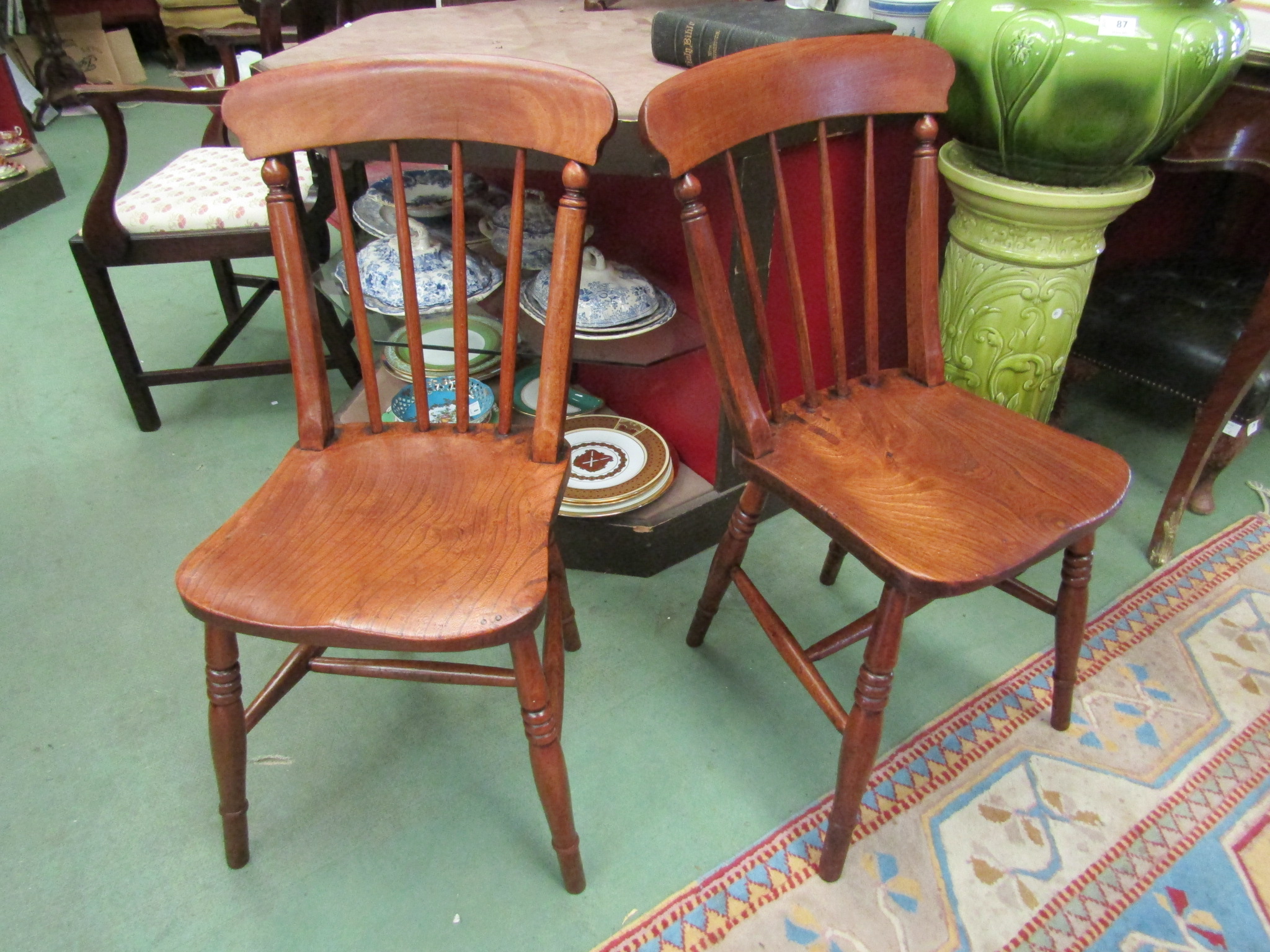 A pair of elm seat stick-back Windsor chairs circa 1860 on turned legs joined by stretchers,