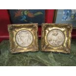 A pair of ornate gilt framed ecclesiastical scene plaques depicting putti and classical couple,