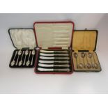 Two cased sets of silver teaspoons and a cased set of silver handled butter knives