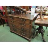 A George III mahogany chest of four graduating long drawers with brass swan neck handles.