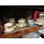 Seven pairs of cabinet cups and saucers and a glass custard cup