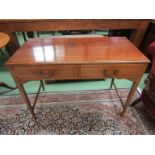 An Edwardian crossbanded mahogany side table the two frieze drawers over square tapering legs,