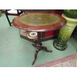 A Victorian walnut oval top wine table with gilt tooled leather inset on a turned column and tripod