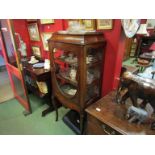 Circa 1840 an inlaid mahogany vitrine the three quarter brass balustrade over a cushioned top and