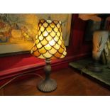 A Tiffany style table lamp with amber and cream shade