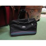 A vintage 1970's Revelation black holdall with side zipper pocket,