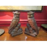 A pair of black forest style carved wooden bookends in the form of owls, approximately 15.