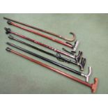 Six walking sticks including silver collared example with horn handle