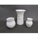 Three West German Kaiser Keramik white matte vases with floral relief detail. Tallest 20cm.