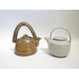 Two studio pottery teapots, one salt glazed with blue roundels and line detail, ceramic handle,