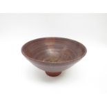 A studio pottery pedestal bowl, poured glazed detail,
