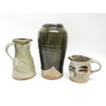 A Trevor & Pam Nicklin Pottery tall vase, dipped tenmoku glaze, impressed amrks, 29cm high.