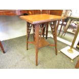 An Arts & Crafts oak square form occasional table with pierced supports and under tier,