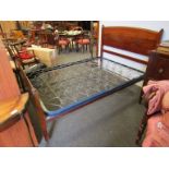 An Edwardian mahogany double bed with metal frame,