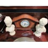 A mantel timepiece and pair of busts