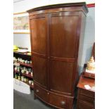 An early 20th Century mahogany bow-fronted two door wardrobe