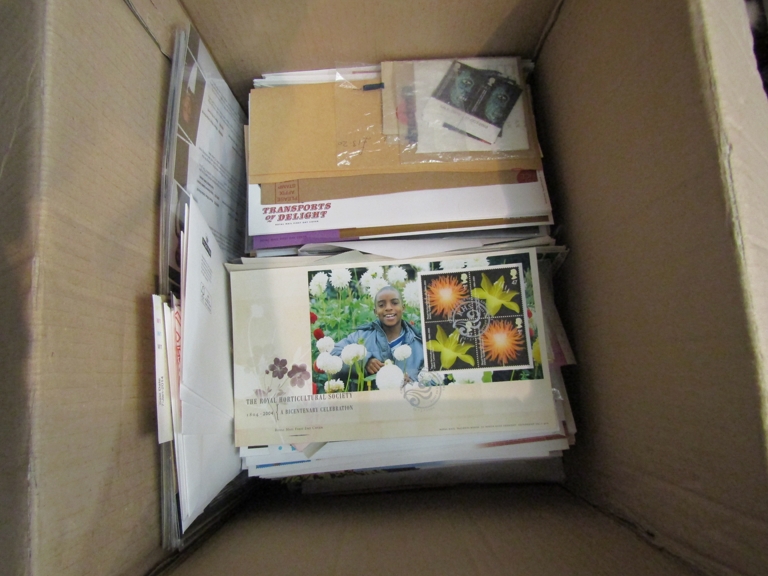 A box of first day covers and mint stamps