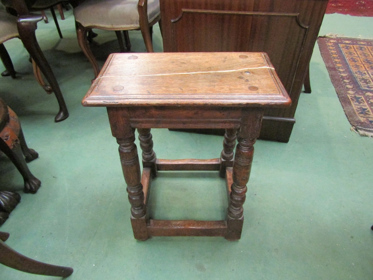 A 17th Century style oak joined stool, turned supports and box stretcher base,
