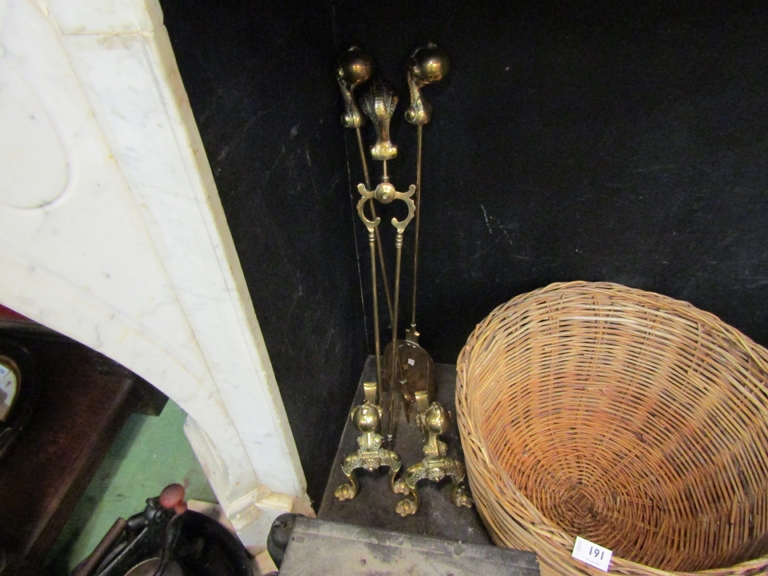 A set of brass fire tools with claw and ball finials with a pair of matching fire dogs