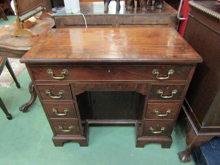 An 18th Century and later mahogany kneehole desk, eight drawers and recessed door,