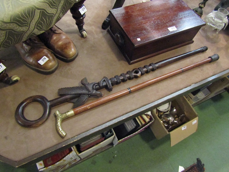 An African hardwood carved walking cane with bird detail and a brass top walking cane with hidden