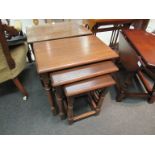 A modern nest of three oak tables