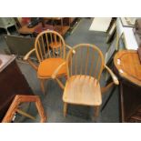 An Ercol stickback armchair and matching chair