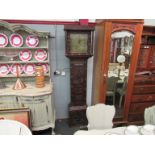 A Victorian heavily carved oak grandfather clock with pendulum and weights