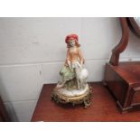 A Capodimonte Italian porcelain figure of seated female with sheep on cast metal base,