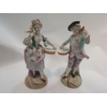 A pair of Continental ceramic figurines depicting lady and gent with flower baskets,