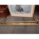 A Victorian brass fire fender with spindle rail,