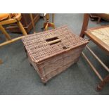 A wicker lidded basket with grab handle