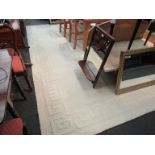 A white 'Greek Key' wool rug,