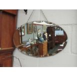 An Art Deco oval wall mirror,