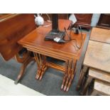 A nest of three yew wood tables