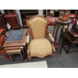 A Victorian walnut armchair with gold velour upholstery and line inlaid embellishment