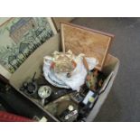 A box containing assorted items to include a pair of bellows, various clocks, dinner plates,