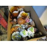 A box containing assorted ceramics and collectables to include teapots,