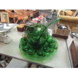 A green glass punch set
