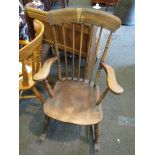An early 20th Century elm seated rocking chair