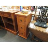 A pine three drawer slim unit,