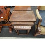 A nest of three oak tables