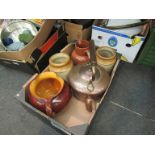 A box containing two pottery handled jugs,