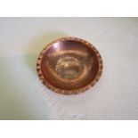 An Arts & Crafts copper hand beaten bowl marked LRI Borrowdale,