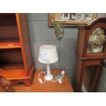 A Shabby-Chic style bedside table lamp with white and blue linen shade and an Eastern style