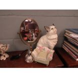 A ceramic cat, mirror,