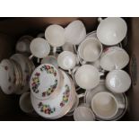 A box containing white ground dinner wares and two tea sets
