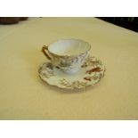 A cabinet cup and saucer painted with poppies and cornflower's on porcelain.