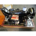A 1950's cased Singer electric sewing machine with foot pedal