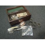 A burr inlaid box containing a quantity of EPNS ware including napkin rings, cutlery,
